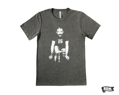 May include: A gray t-shirt with a graphic of a man riding a bicycle. The man has a mustache and is wearing a jersey with the number 26. The t-shirt has a crew neck and short sleeves. The Zen Threads logo is visible in the bottom right corner.